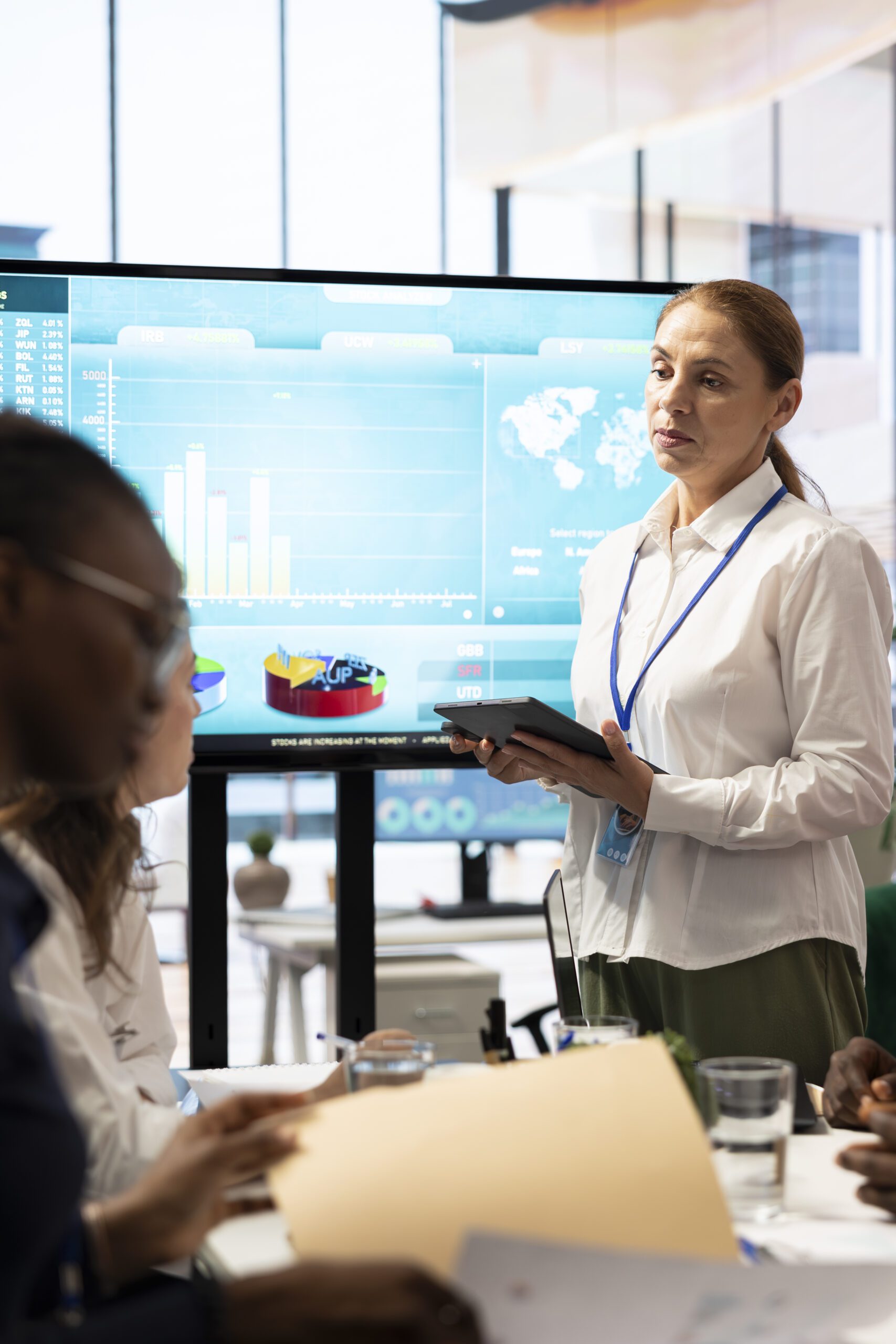 Teammates assembling in a boardroom to go over their analysis results Teammates assembling in a boardroom to go over their analysis results
