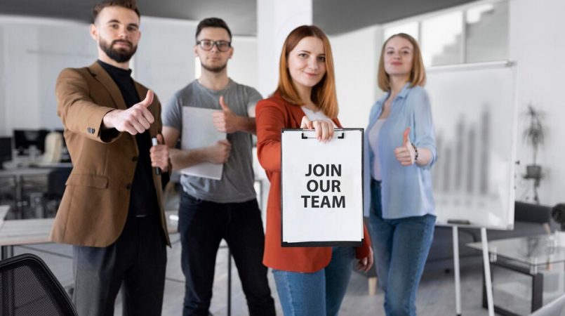 woman-holding-clipboard-with-join-our-team-message